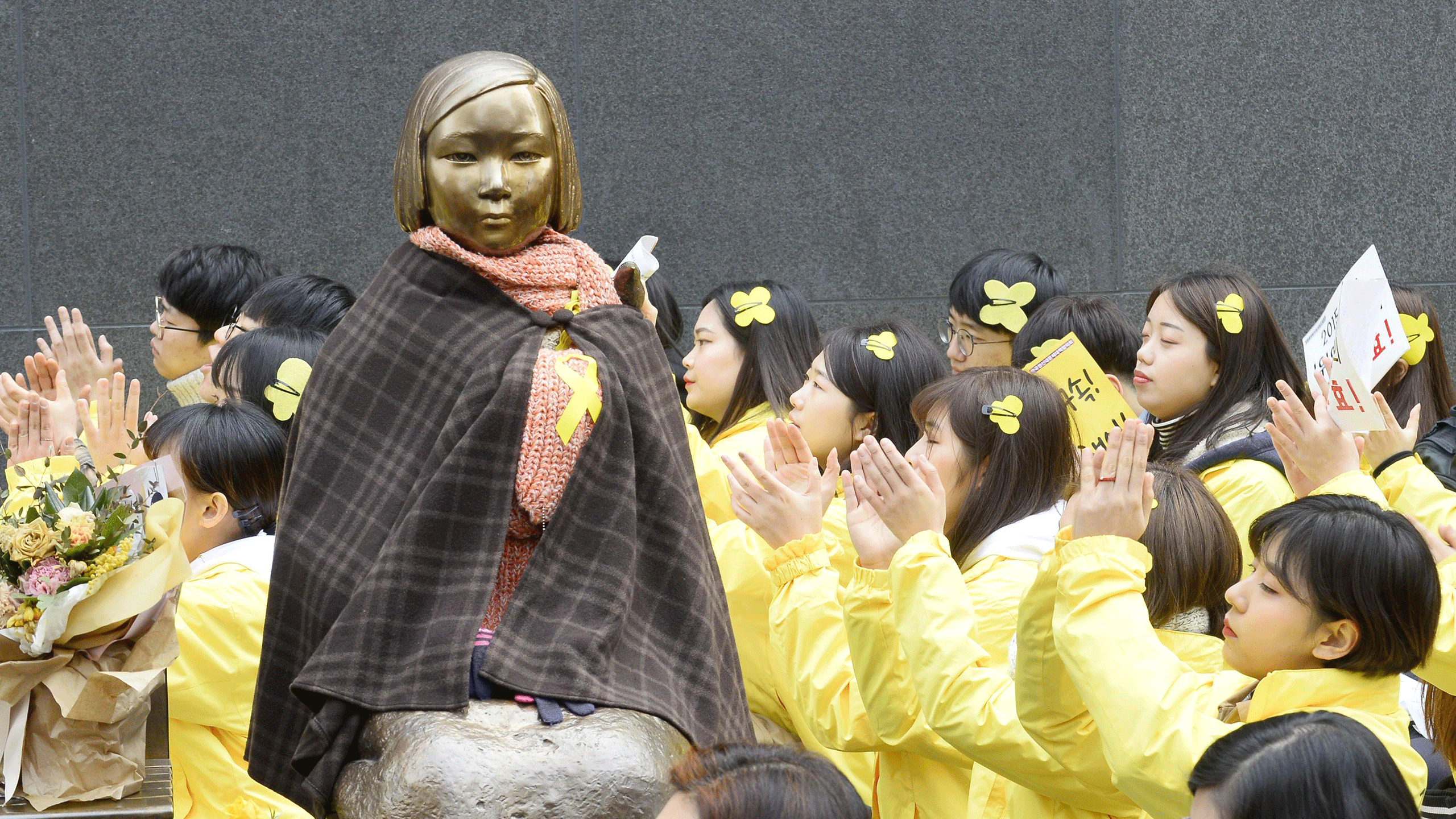 Demonstrators gather in March 2017 around a statue representing former "comfort women" installed in front of the Japanese Embassy in Seoul, to protest against a move to remove it. Photo: Kyodo.